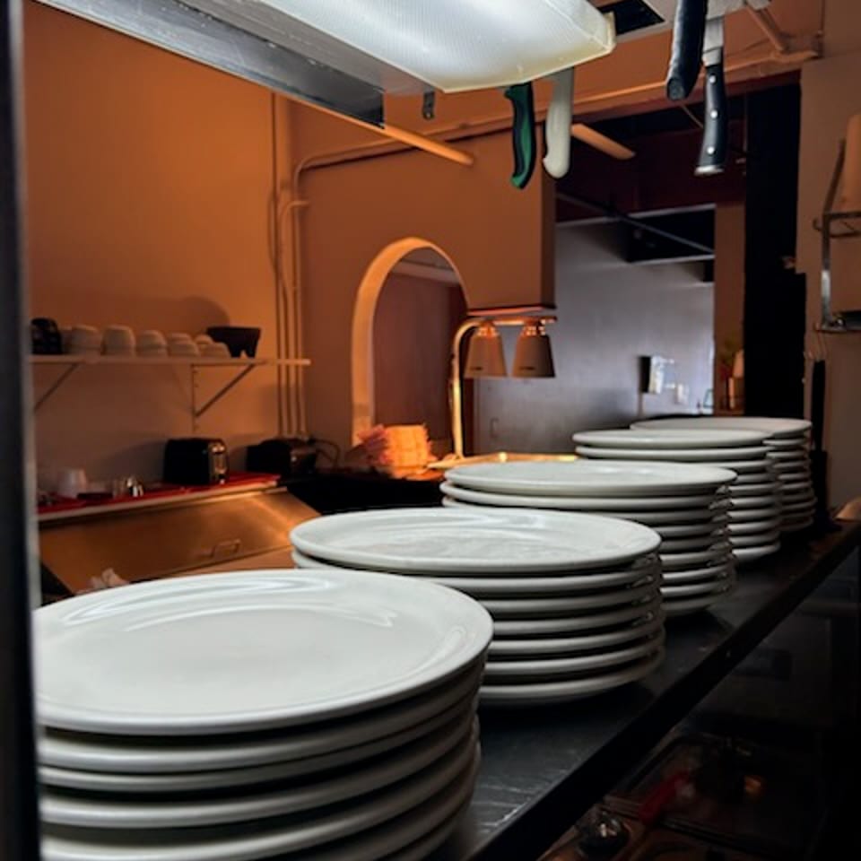 Stacked plates at the restaurant kitchen service counter.
